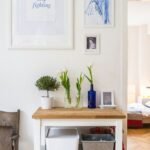 white and brown wooden end table near wall inside room